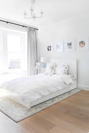 White Twin Bed On Gray Flocked Rug