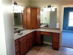 It features classy, wooden cabinets which ideally match earthy tiles on the wall and floor. Bathroom Corner Vanity Cabinet Fanpageanalytics Home Design From Bathroom Corner Cabinet As The Space Saver Solution Pictures