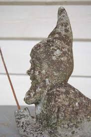 A Cast Stone Figure Of A Gnome Fishing