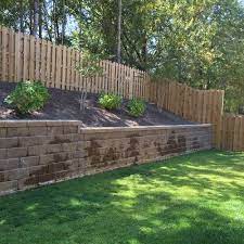 reaching landscaping above a retaining wall
