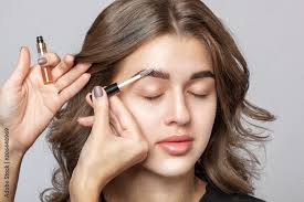 applying brow fix gel on eyebrows face