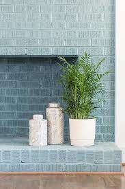 Blue Painted Brick Fireplace With Vases
