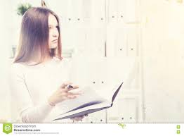 Woman With Book Looking At Business Charts Stock Photo
