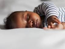 At what age can a baby sleep on their stomach?