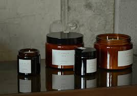 scented candles in amber glass jars