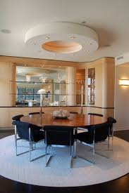 The round dining table highlights the curved lines of the fixture. When To Go Round With Your Rug