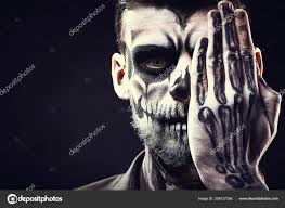 face of man with halloween skull makeup