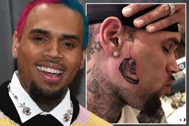 Rihanna has responded to chris brown's recent controversial tattoo by sporting a gold metal grill. Chris Brown News Views Gossip Pictures Video Irish Mirror Online