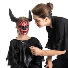a makeup artist makes up a demon to a