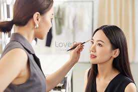 makeup artist puts makeup on model