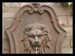 gentle lion head wall fountain water