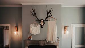 white deer horn wall decor beside skirt