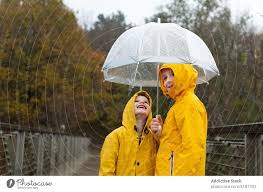 cheerful kids in yellow raincoats on