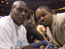 NFL stars Takeo Spikes (left) and Ray Buchanan take in 2005&#39;s home opener against the L.A. Lakers - Spikes_RayBuchanan_on05_460