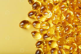 pile of golden capsules of vitamin d3