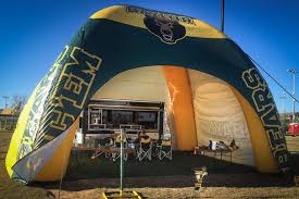 Large, customized inflatable tent provides plenty of space and shade for  festive gameday fun.