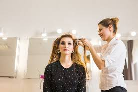 hairdresser doing hair style for woman