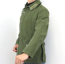 The blended cotton canvas jacket shell features two deep bellow style hip pockets, button closures, and a concealed drawstring waist. Swedish Army M59 Combat Jacket