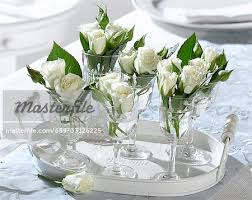 White Roses In Wine Glasses