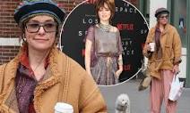 Parker Posey is almost unrecognizable in heavy coat with glasses ...