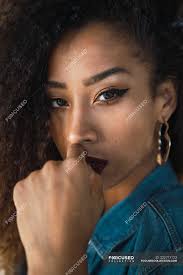 dark curly hair in denim shirt