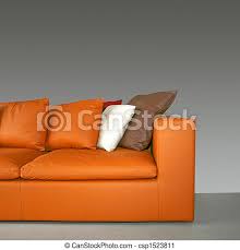 Orange leather sofa are available in various materials such as wood, cane, bamboo and soft sets, to cater to unique aesthetic choices and provide ultimate comfort to the user. Orange Sofa Orange Leather Sofa With Pillows And Grey Wall Canstock