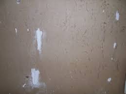 damaged drywall after tile removal