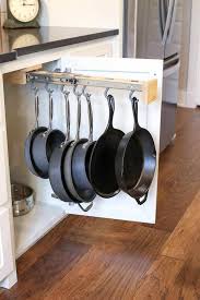 Install shallow wooden box drawers in a base cabinet to stack your pots on their sides. A Picture Of A Pot Hanging Rack Inside Of A Cabinet Hanging Pans Inside Cabinets Kitchen Decor