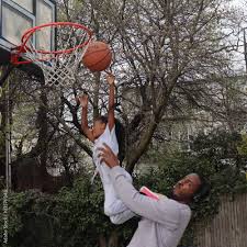 shoot basketball in hoop stock photo
