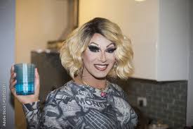 portrait of smiling drag queen holding