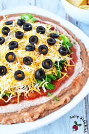 layered taco dip with refried beans