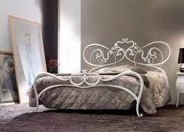 white iron bed frames in modern bedroom