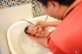Looking for a good deal on baby bath towel boy? Newborn Baby Boy Having Bath In Tubby On Father S Hand Newborn Baby S First Bath Stock Photo Picture And Royalty Free Image Image 128155075