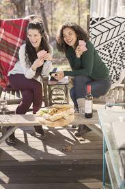 Friends laughing stock photos and images. Two Young Female Friends Laughing Playing Card Game On Patio Togetherness Cold Stock Photo 171407540