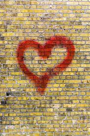 Heart Graffiti On A Yellow Brick Wall