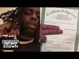 rapper bagzamilleon shows paper work to