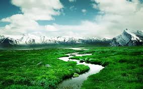 mountains with snow green meadow flow