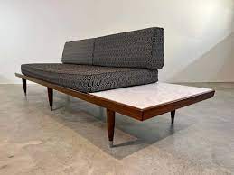 mid century platform sofa in the manner