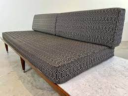 mid century platform sofa in the manner