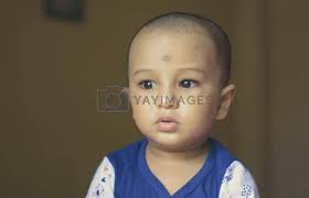 cute bald indian baby boy in blue and