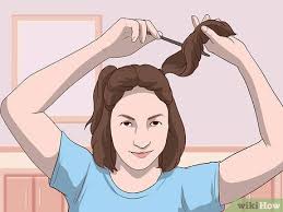 Secure it with a small hair tie, then make a hole in the middle and 'topsy tail' it. 3 Simple Ways To Do Space Buns On Short Hair Wikihow