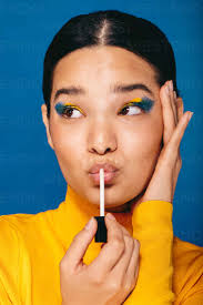 vibrant young woman applies makeup on