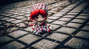 white face red hair doll sitting