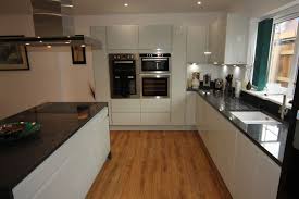 white gloss kitchen with black granite