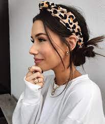 A bun that is pulled back too. Leopard Print Headband Messy Low Bun With Leopard Print Headband And Gold Jewelry Headband Hairstyles Hair Styles Scarf Hairstyles
