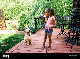 Girl blowing bubbles dog in hi-res stock photography and images - Alamy