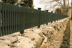 a fence to a retaining wall