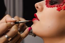 makeup artist painting the lips
