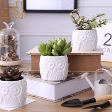 Common plant pot materials include metal, wood, plastic, concrete and another stoneware such as ceramics. China Owl Shape White Ceramic Plant Pot With Treetop Wooden Stand Photos Pictures Made In China Com
