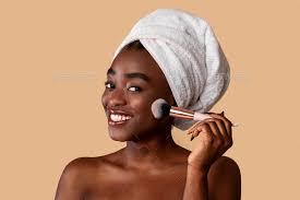 black woman applying makeup